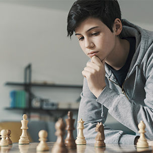 teen boy playing chess